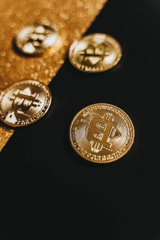 Gleaming Bitcoin coins on a black and gold background