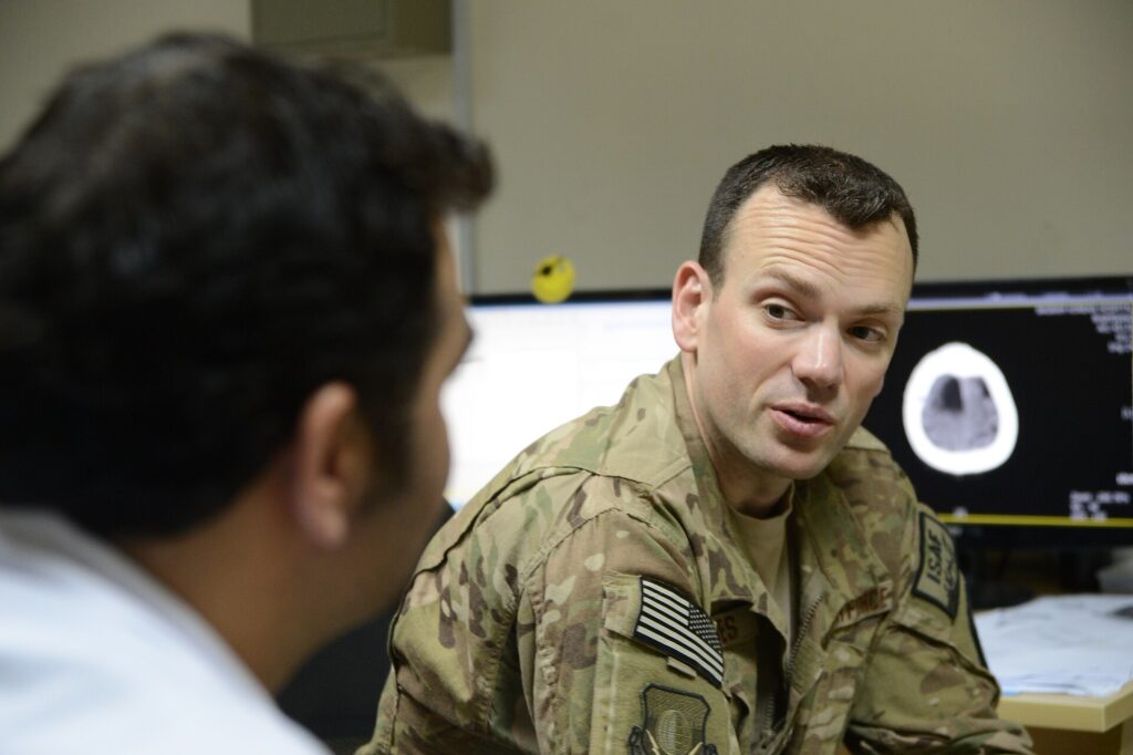 A GP talking with a patient during a consultation in a primary care surgery.